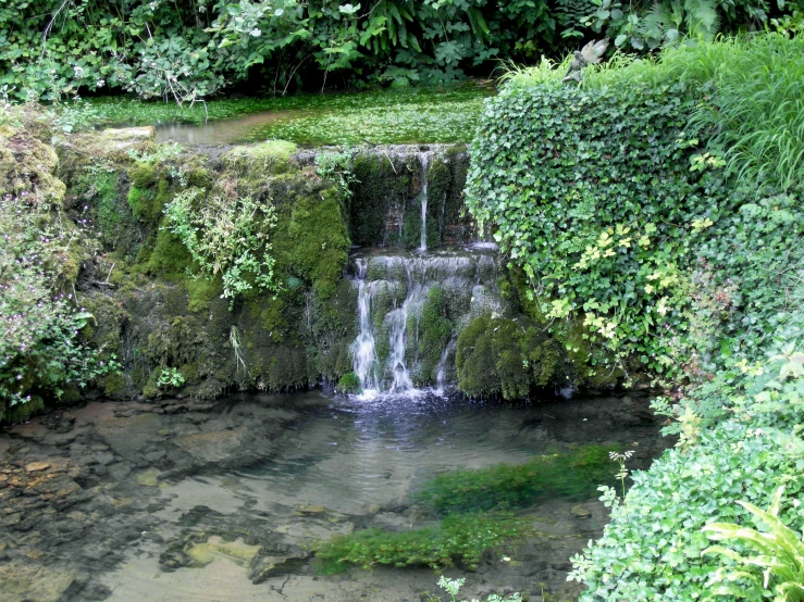 a couple of waterfalls are running over the side of a cliff