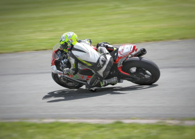 a motorcycle riding on the road near the grass