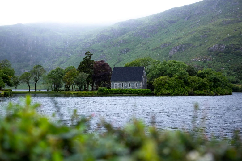 a house near a lake with a few trees