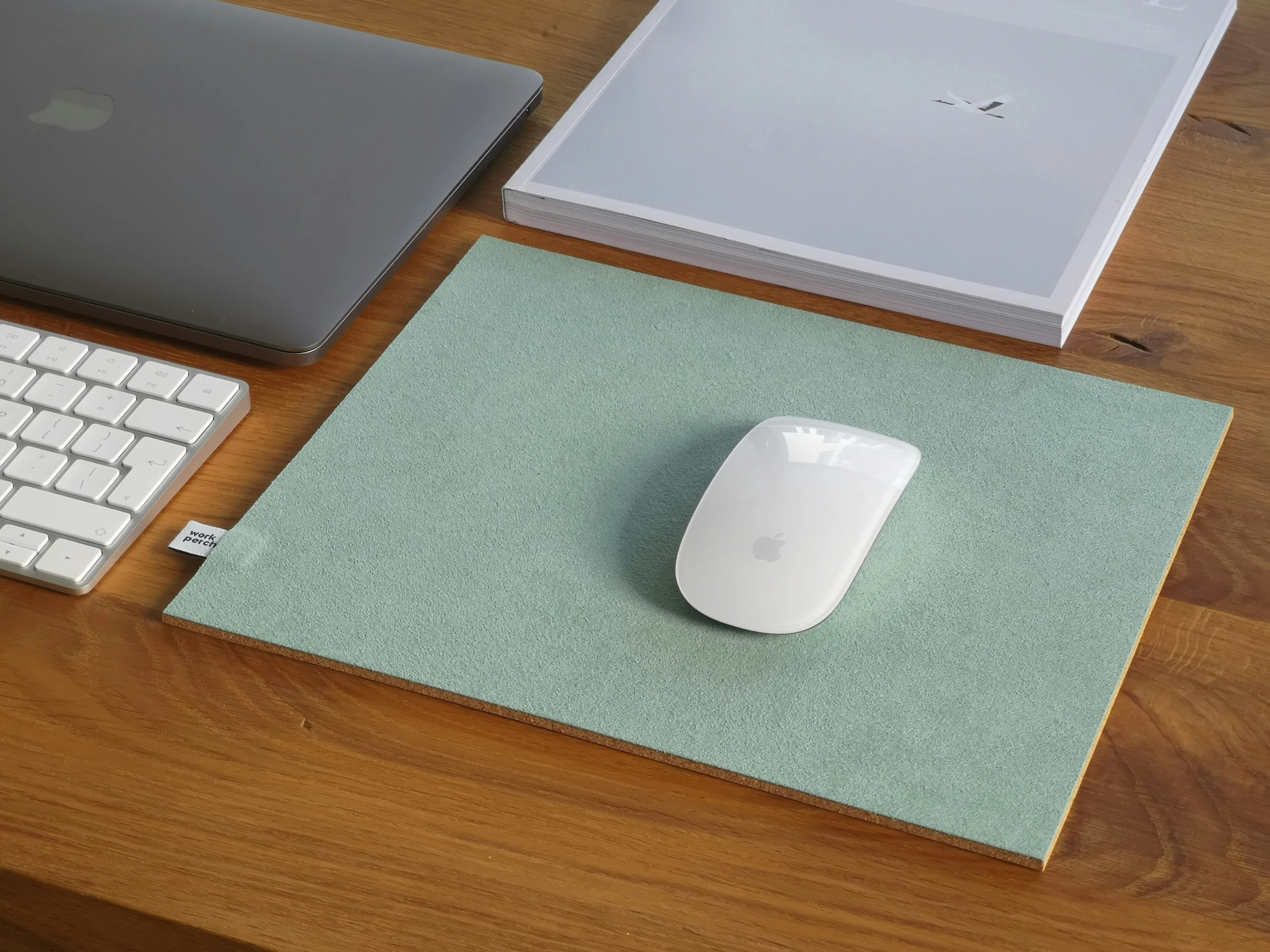 apple mouse and computer keyboard laid out on table