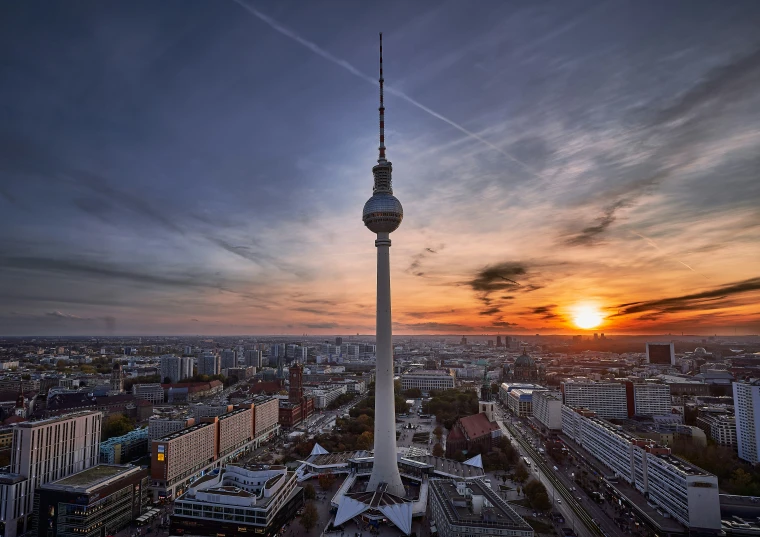 the tower at dusk is on the corner of the city