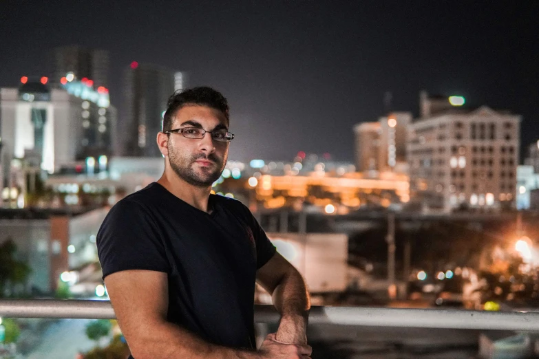 a man standing on the side of a balcony