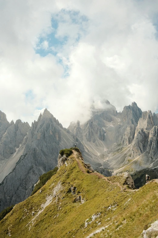 the top of the mountain is covered with clouds