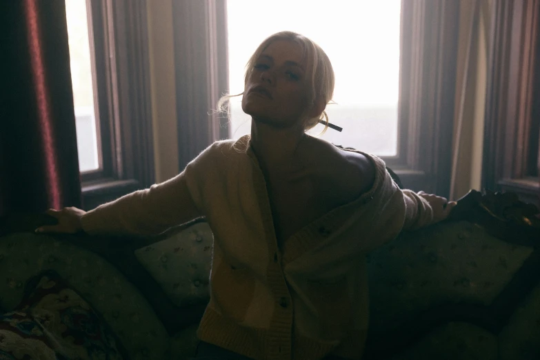 a woman looks up as she sits on a couch