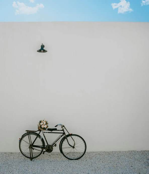 a bicycle with two bicycles on the back parked next to it