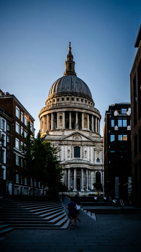 a person with an umbrella is standing outside the dome of a building