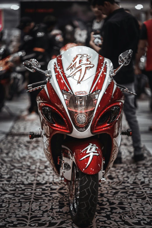 a red and white motorcycle is on display