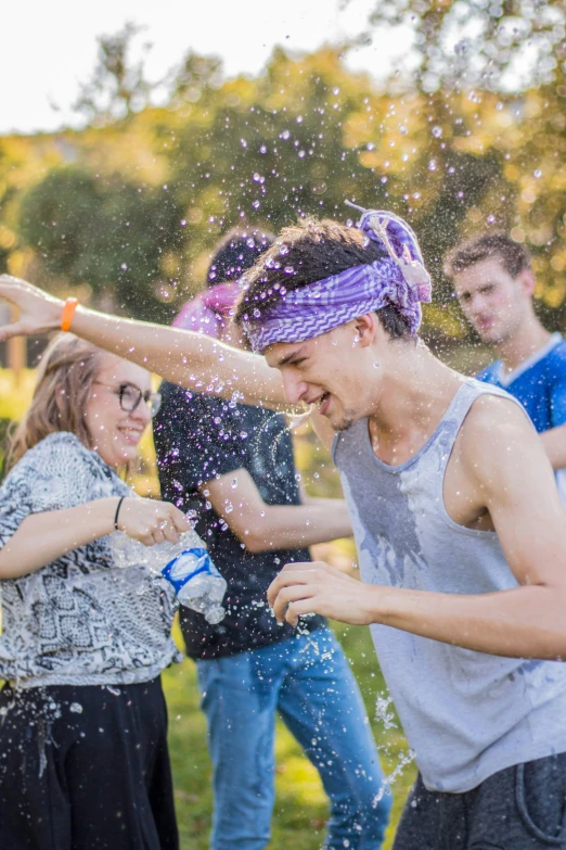 a man and a woman splash water on each other