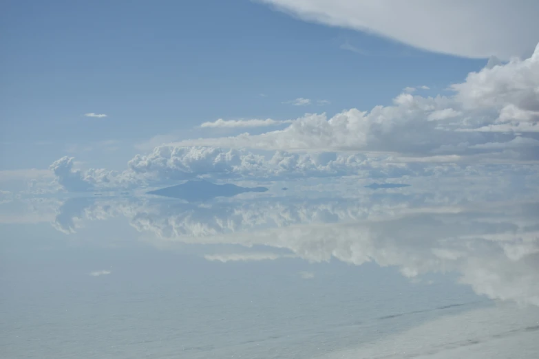 an ocean is full of clouds and clear blue skies