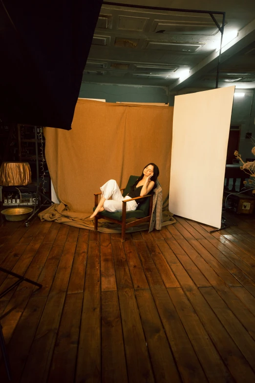 a woman laying in a chair near an open box