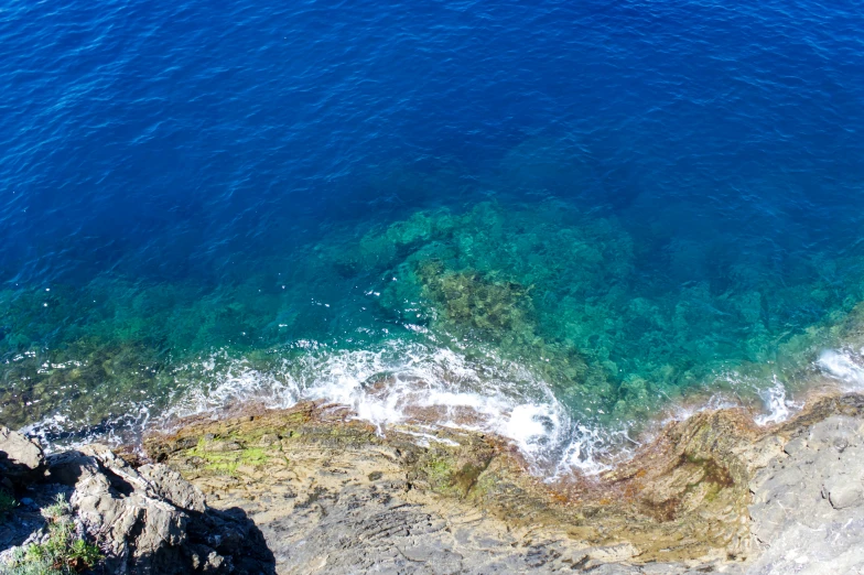 a rock and water with a view of the ocean