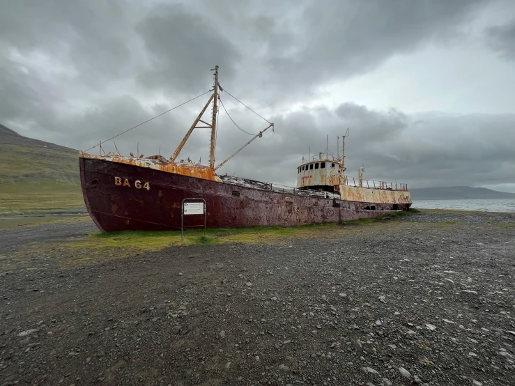 a large boat sitting on top of gravel