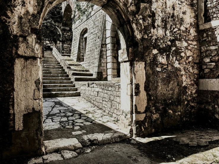 an archway with steps leading to the building