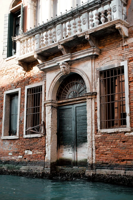 an old brick building with green water running around it