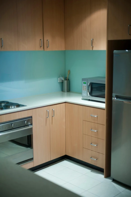 a very small and clean kitchen with a refrigerator