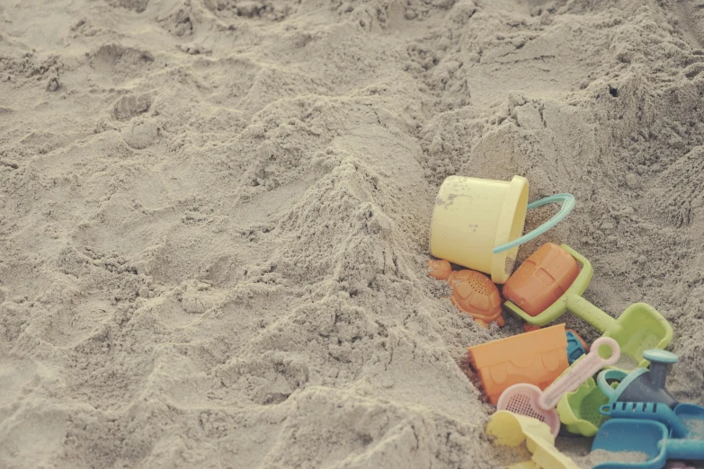 small toys on a beach with sand on the background