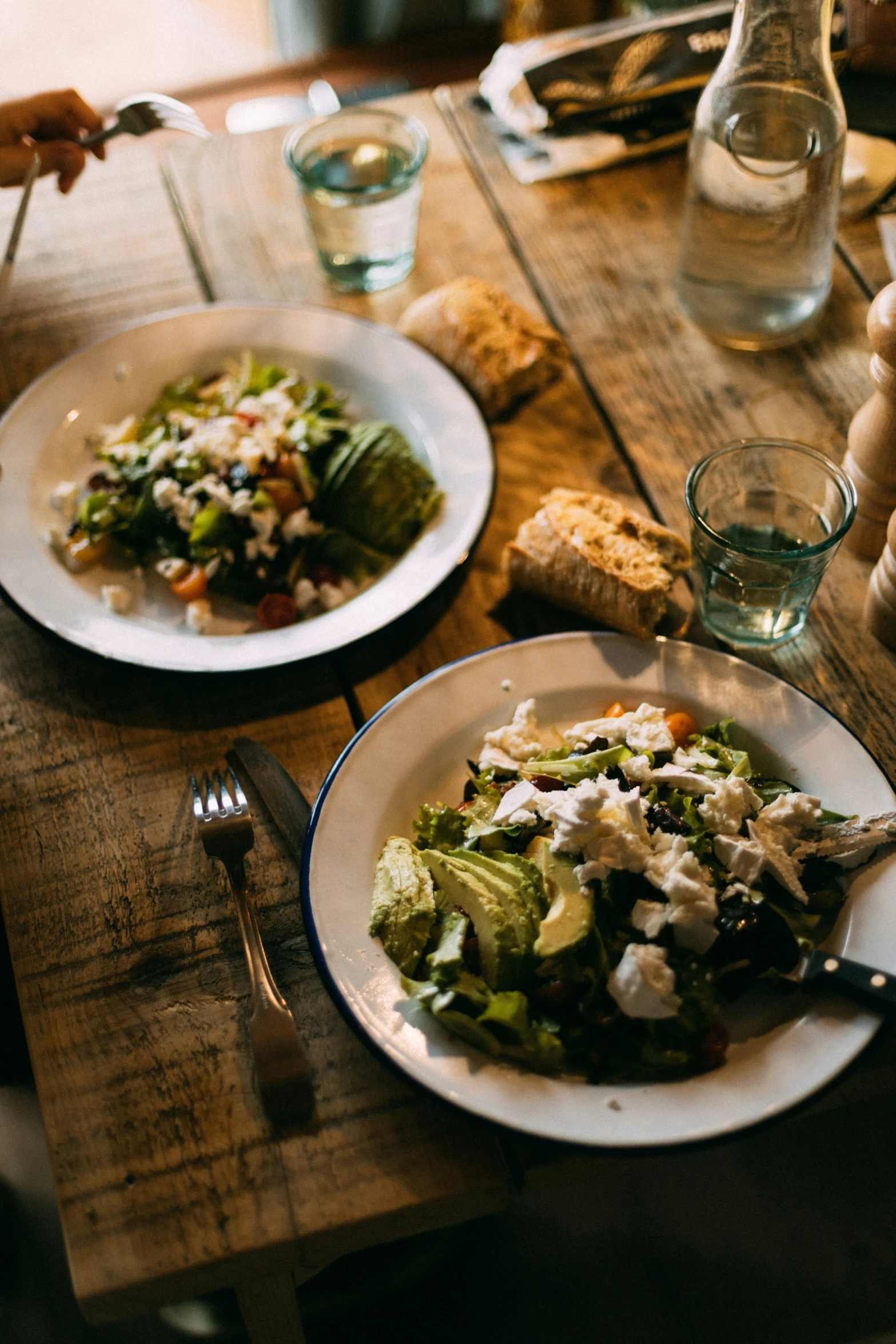 a dinner table with plates of food and a fork