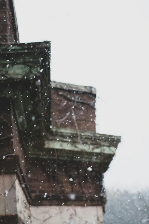 a very tall building with snow falling from it