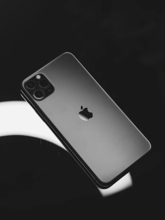 an apple phone is shown in this black and white po