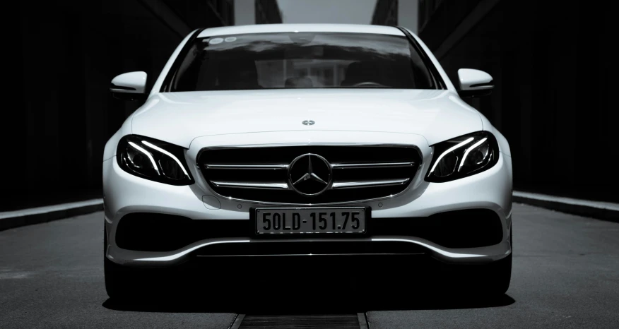 a white mercedes benz coupe parked in a garage