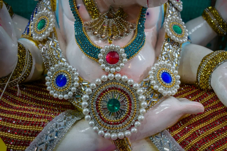 statue of hindu god with many decorations on his body