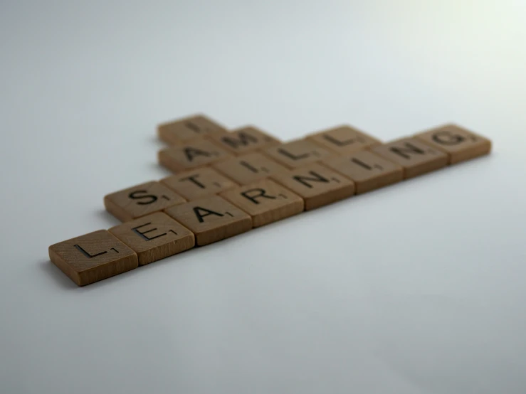a scrabbled word spelled out in brown text on white background