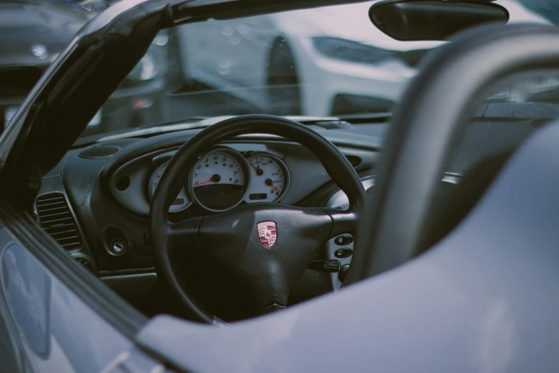 a grey and black sports car driving on street