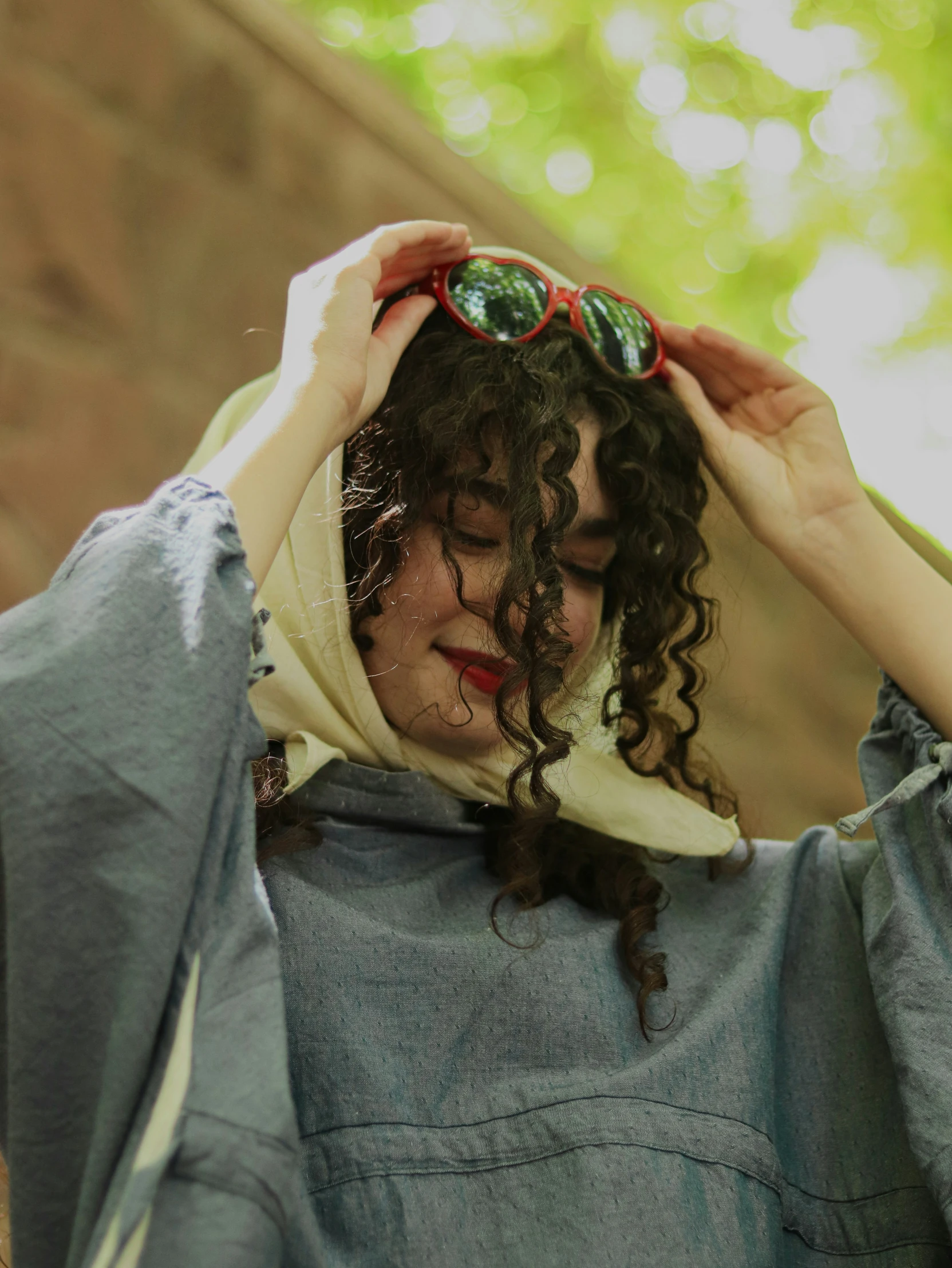 a woman with a pair of green sunglasses covering her eyes