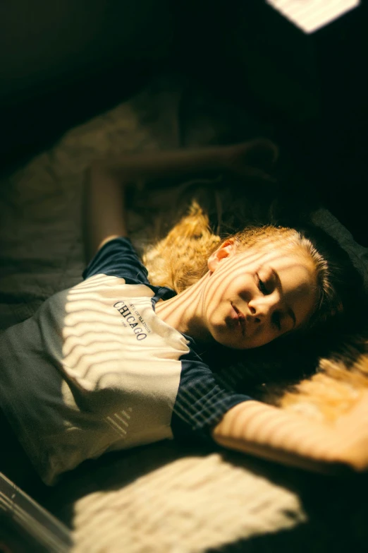 a woman lying on a bed in the dark