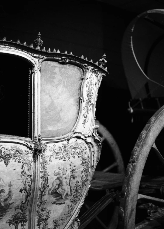 a white horse and carriage traveling through a dark room