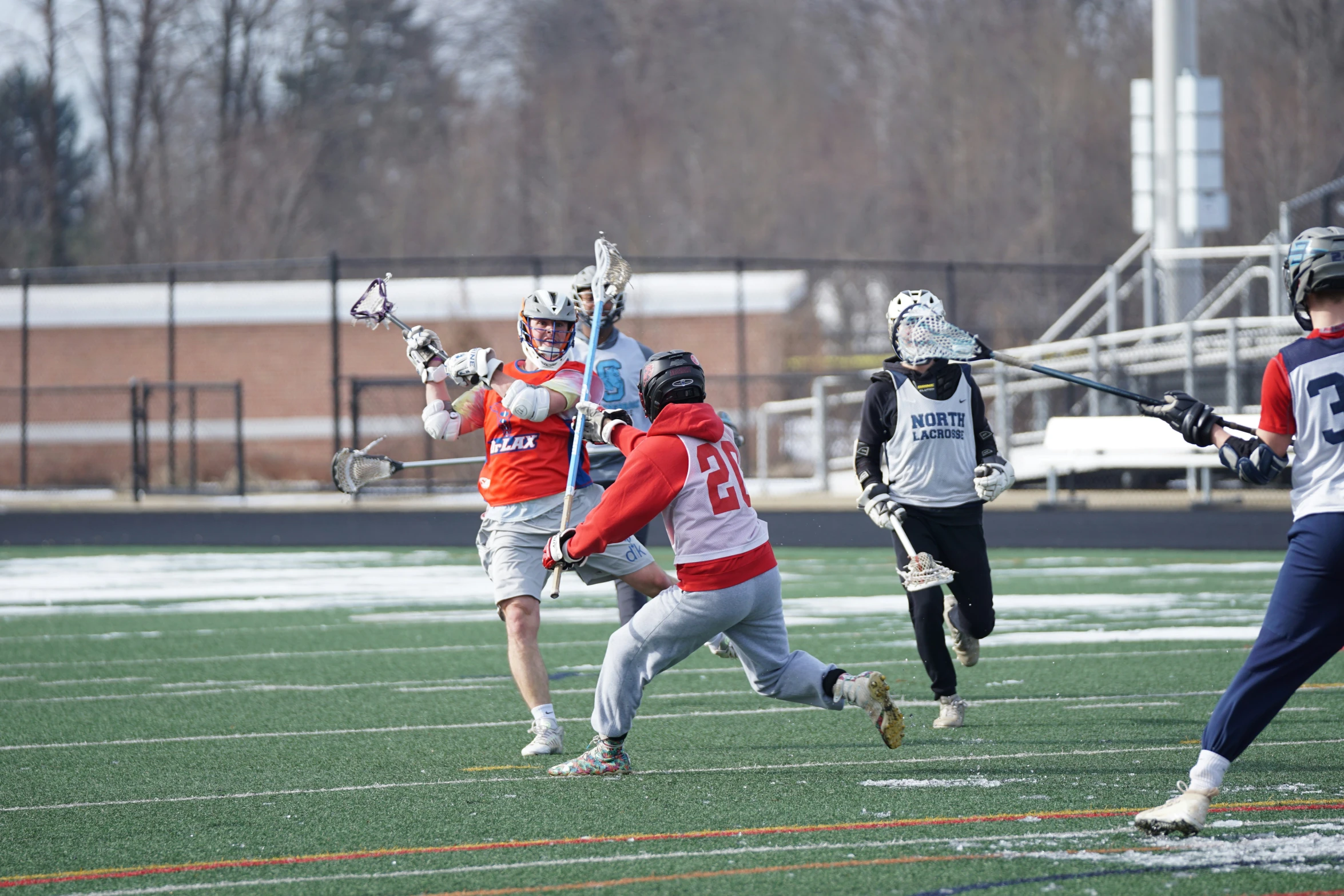 a group of people playing a game of lacrosse