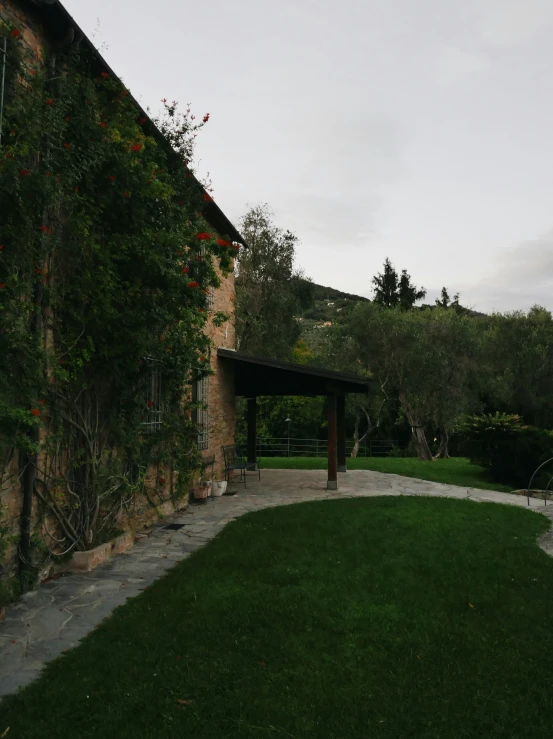 a building covered in vines and a walkway