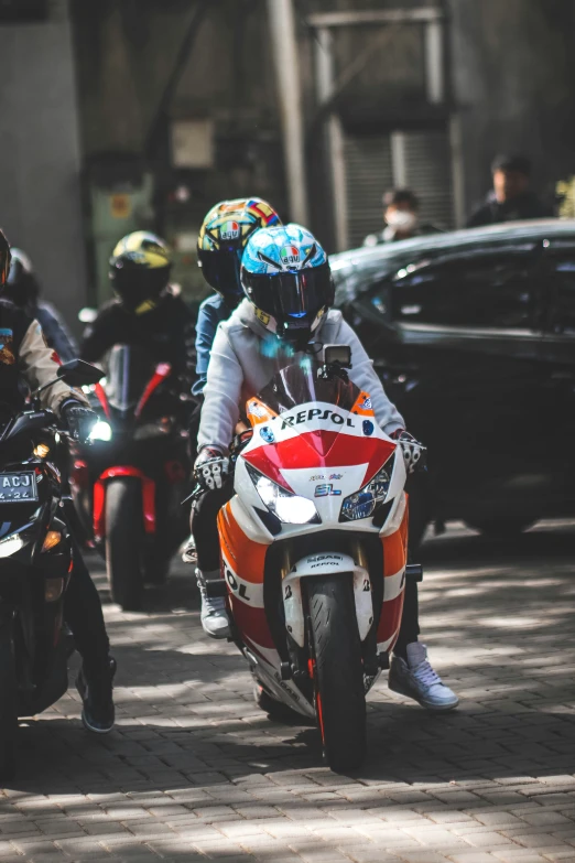 two people on motorcycles with helmets driving on the road