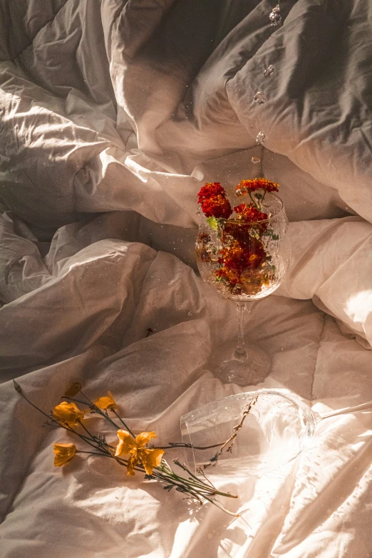 a bunch of flowers laying on some fabric