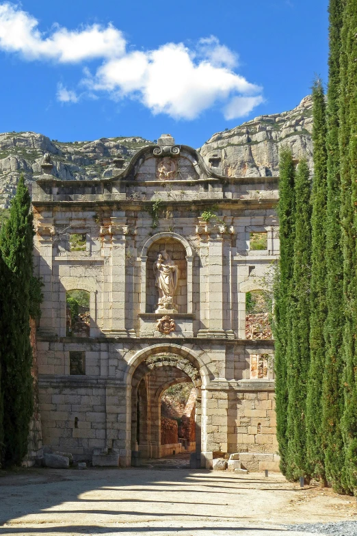 an old castle in a large courtyard surrounded by trees