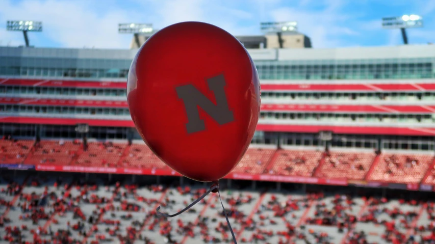 a balloon that is floating in front of a crowd