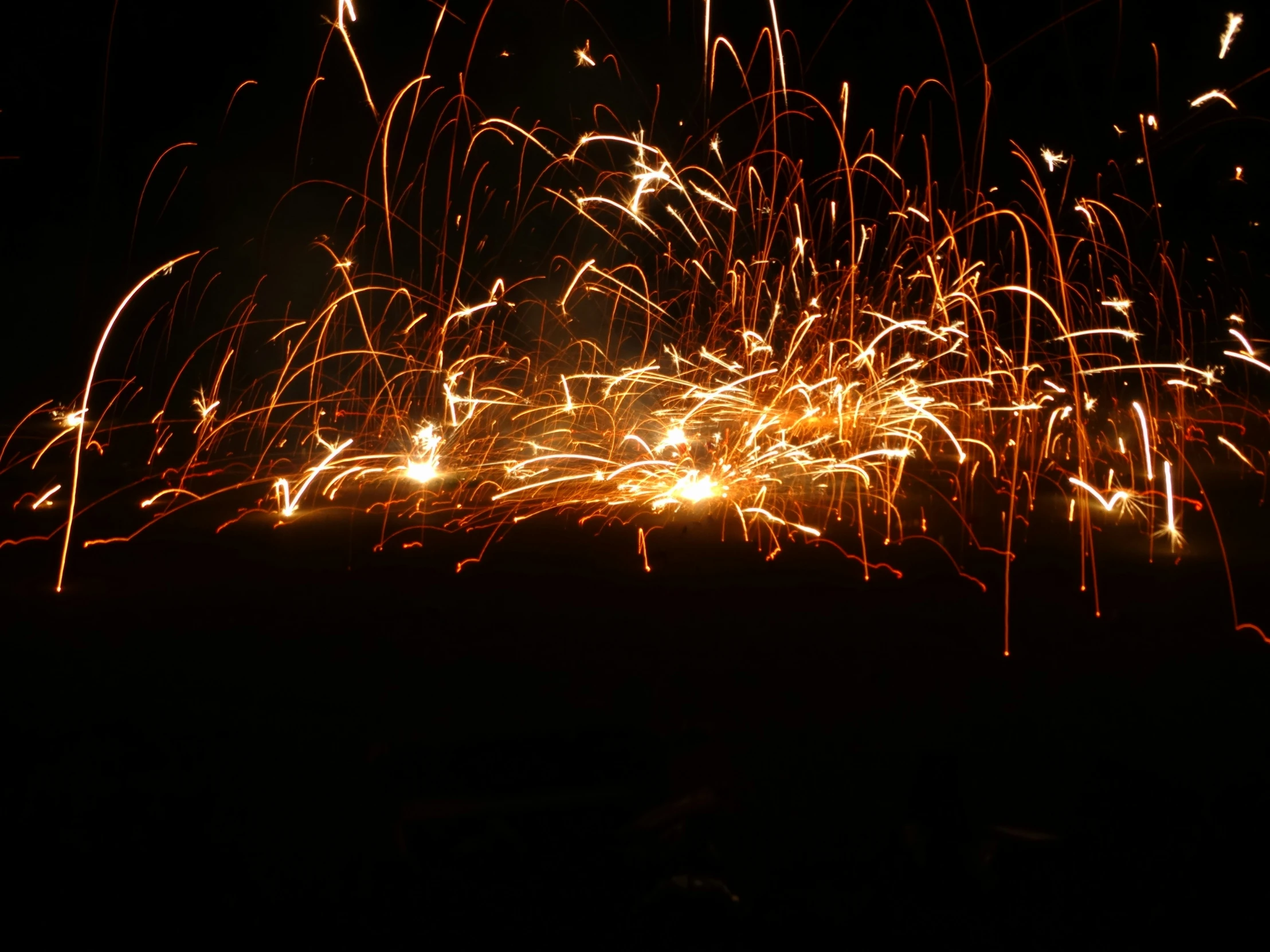 long exposure pograph of fireworks in the dark