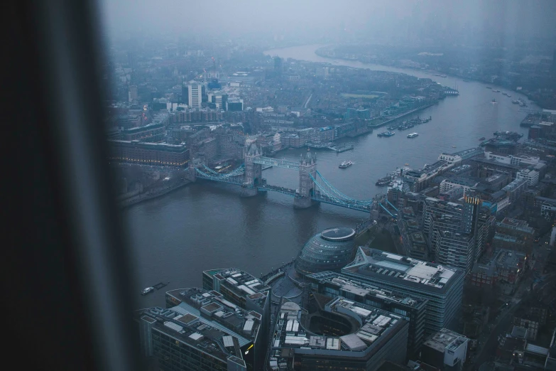 london's city skyline through a window of the buliding