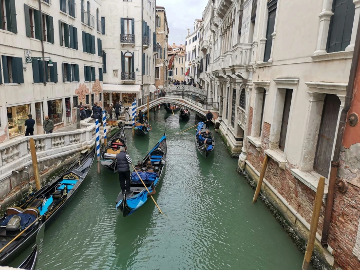 boats on a green canal in italy