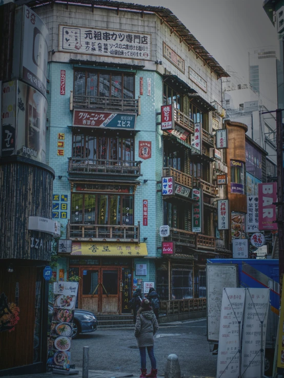 an asian city building with people standing outside