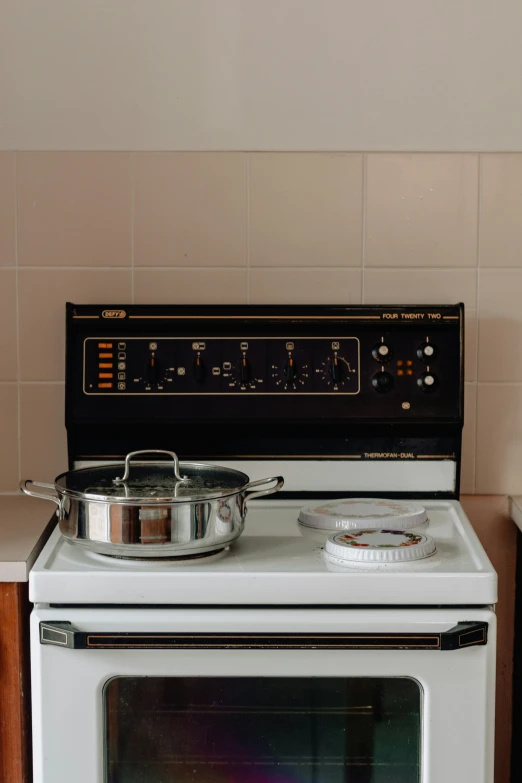 the stove has a pot and pan on it