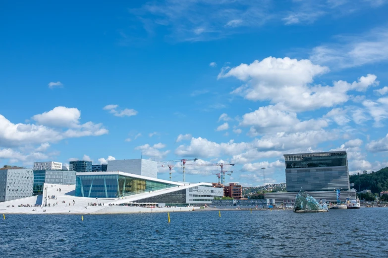 a water front with a white building surrounded by other buildings