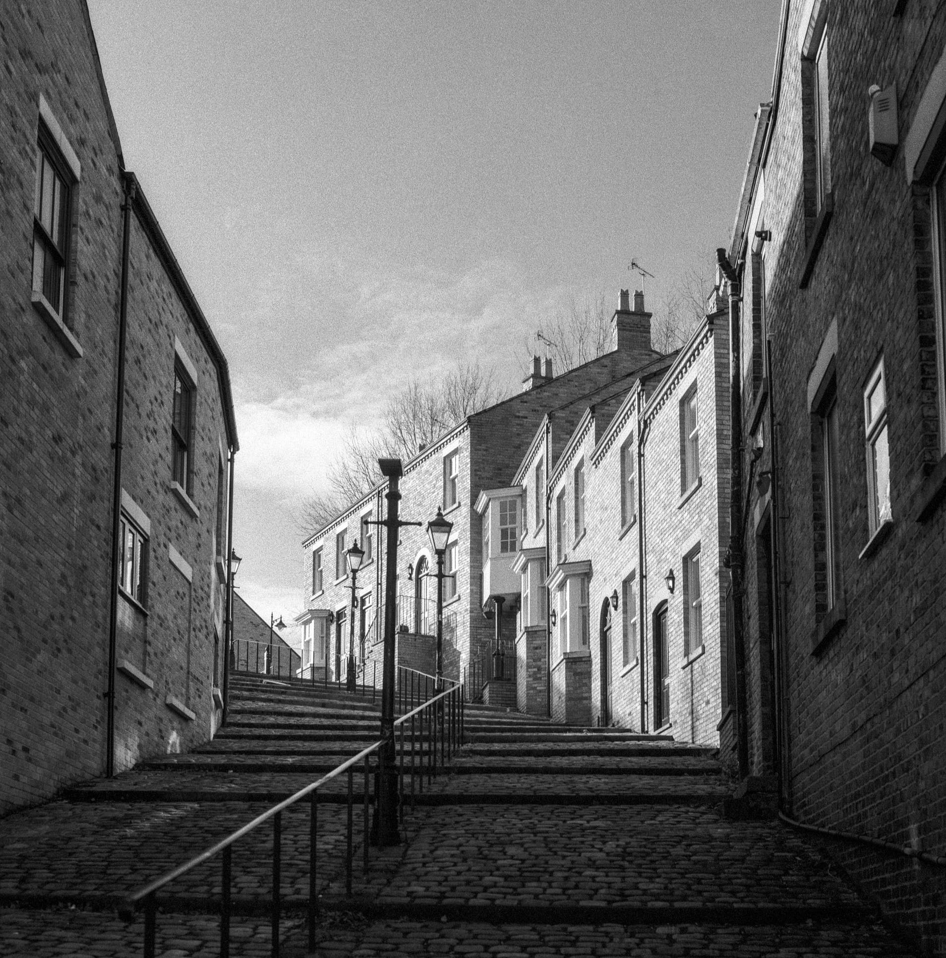 a view of a city street, in black and white