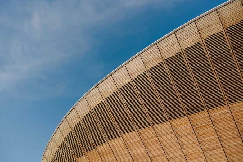 a bird is flying over a building under the blue sky