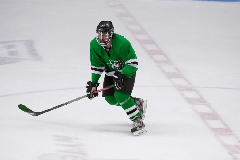 a person in green hockey uniform playing hockey