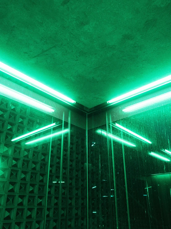 a room with green lights over it and white flooring