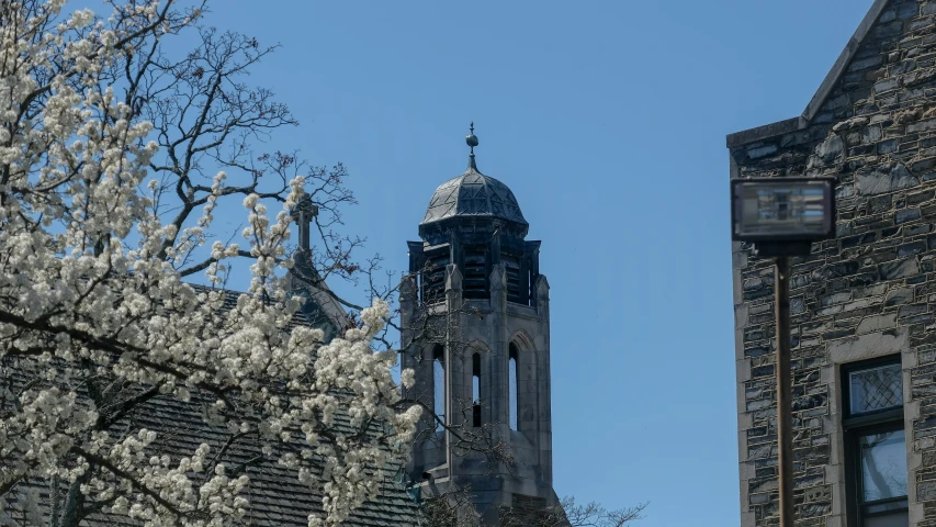 there is a clock on the tower near building