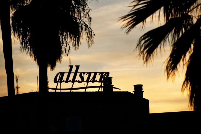 a large rusty sign sitting on top of a building