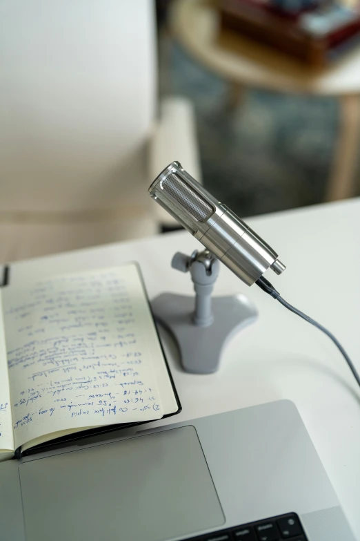 a book and an old fashioned microphone on top of a desk