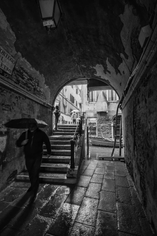 several people walking up a long, dark tunnel